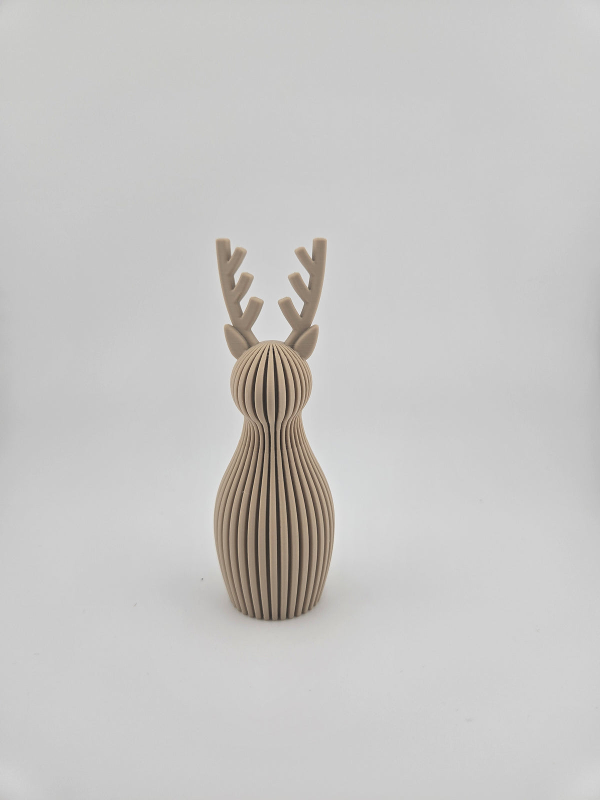 Neutral Beige ribbed Christmas reindeer decoration on a white background