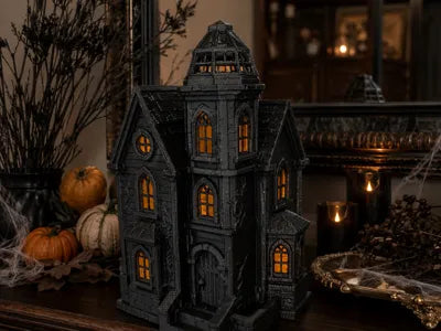 Illuminated Blackthorn Manor displayed with pumpkins in a Halloween setting