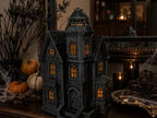 Illuminated Blackthorn Manor displayed with pumpkins in a Halloween setting