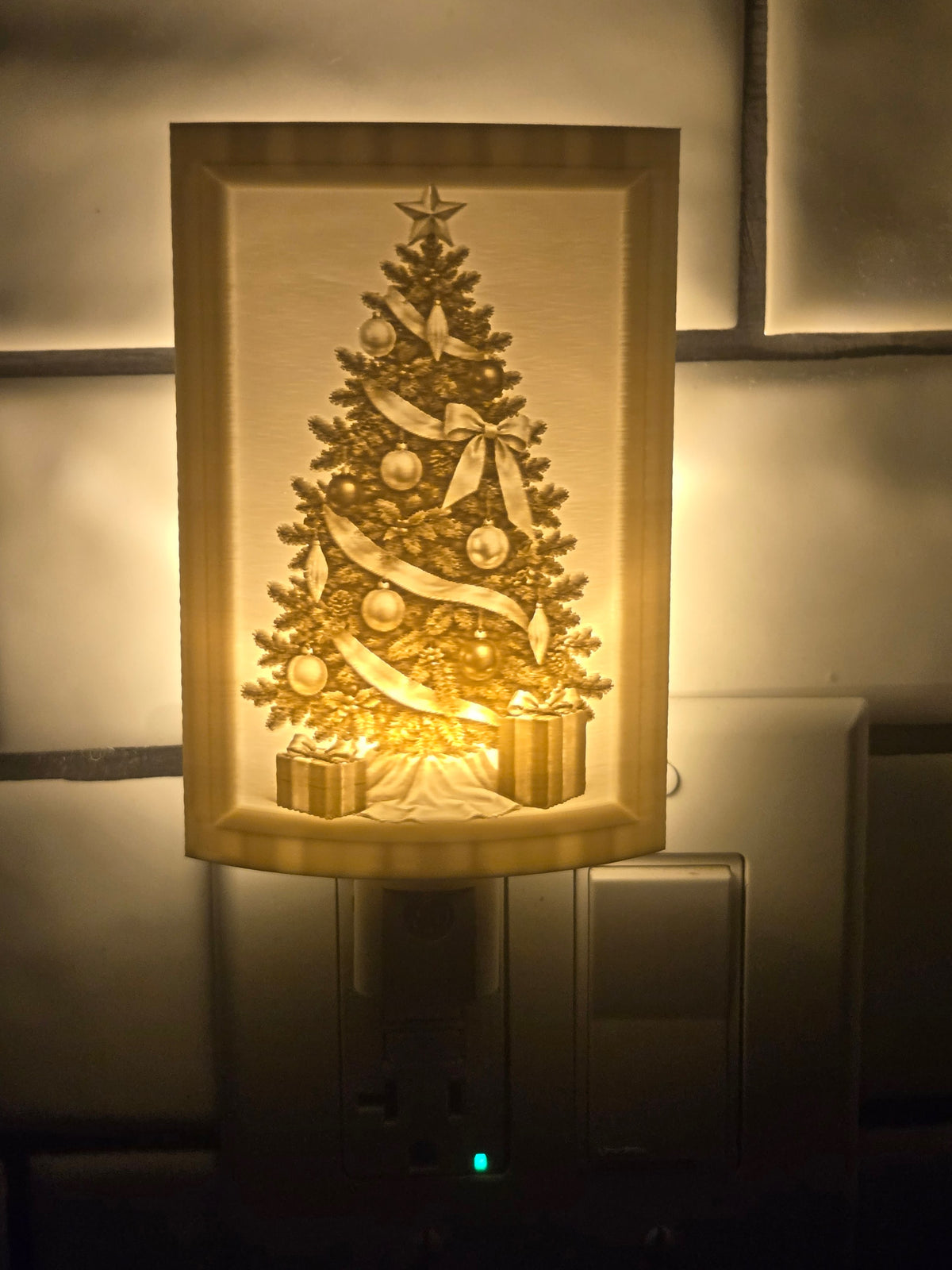 Christmas Tree lithophane motion-sensor night light illuminated in a wall outlet