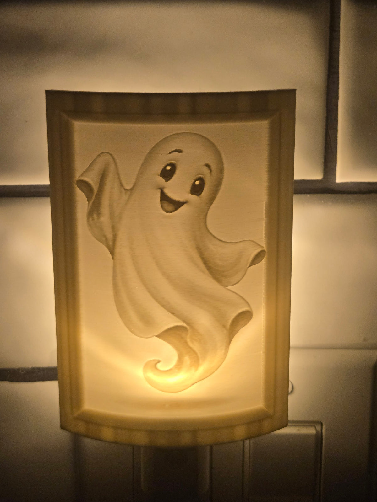 Ghost lithophane motion-sensor night light featuring a smiling Halloween ghost