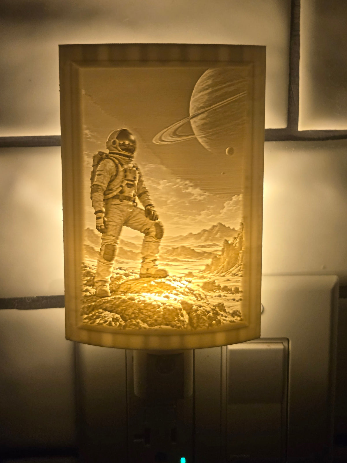 Space lithophane motion-sensor night light featuring an astronaut and a ringed planet